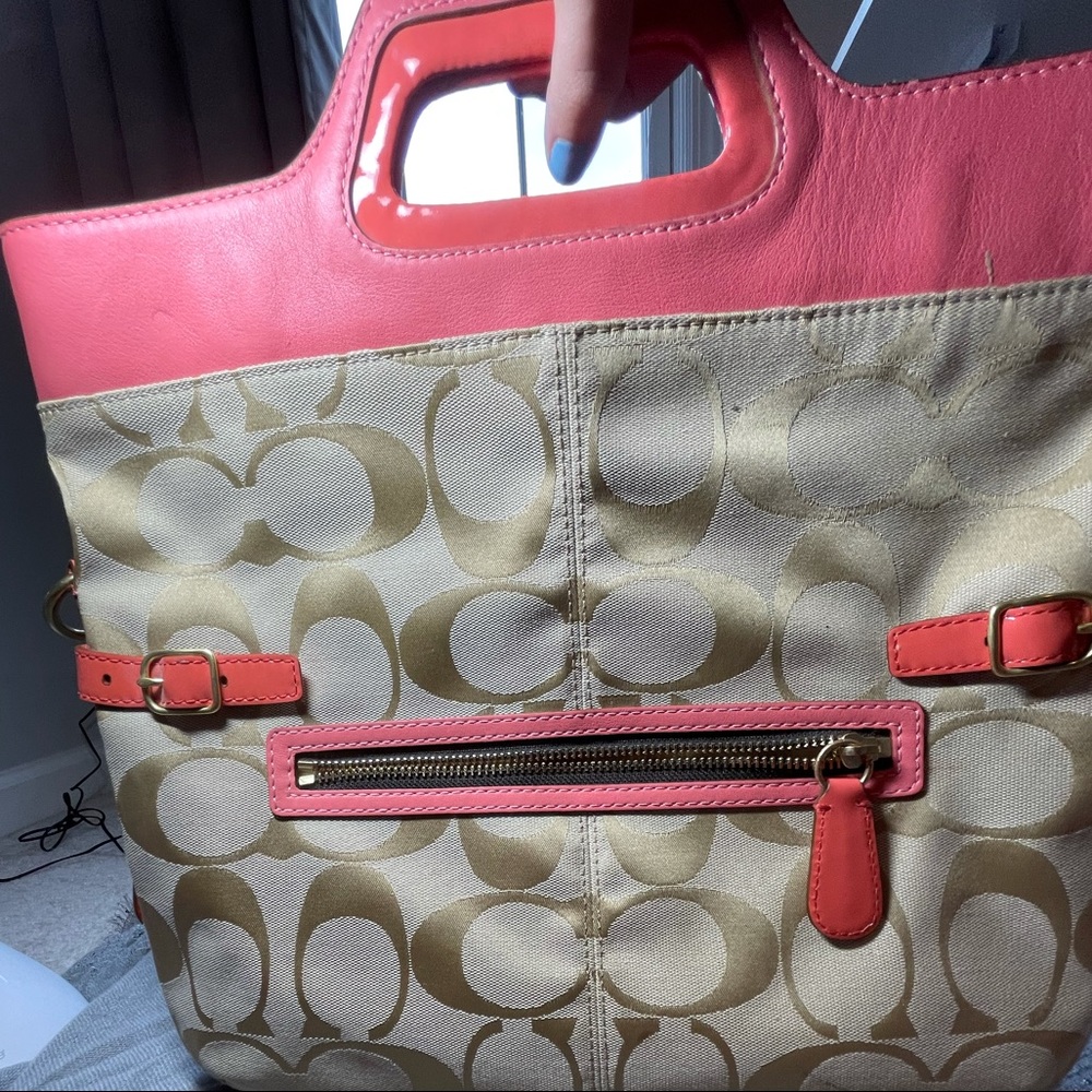 Beautiful pink Coach crossbody bag with strap.